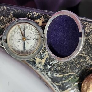 Vintage compass. No chains. Very pretty detail.
